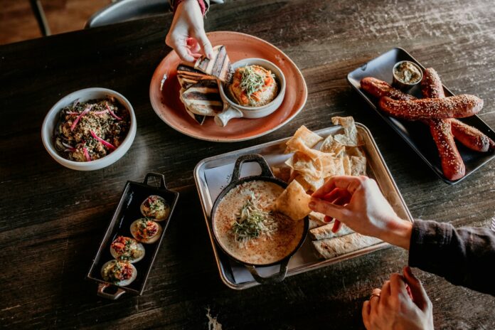 a table topped with plates and bowls of food